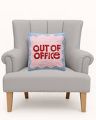 Out of Office Hooked Wool Throw Pillow on an armchair, showing the throw pillow at room scale, 14x14 inch