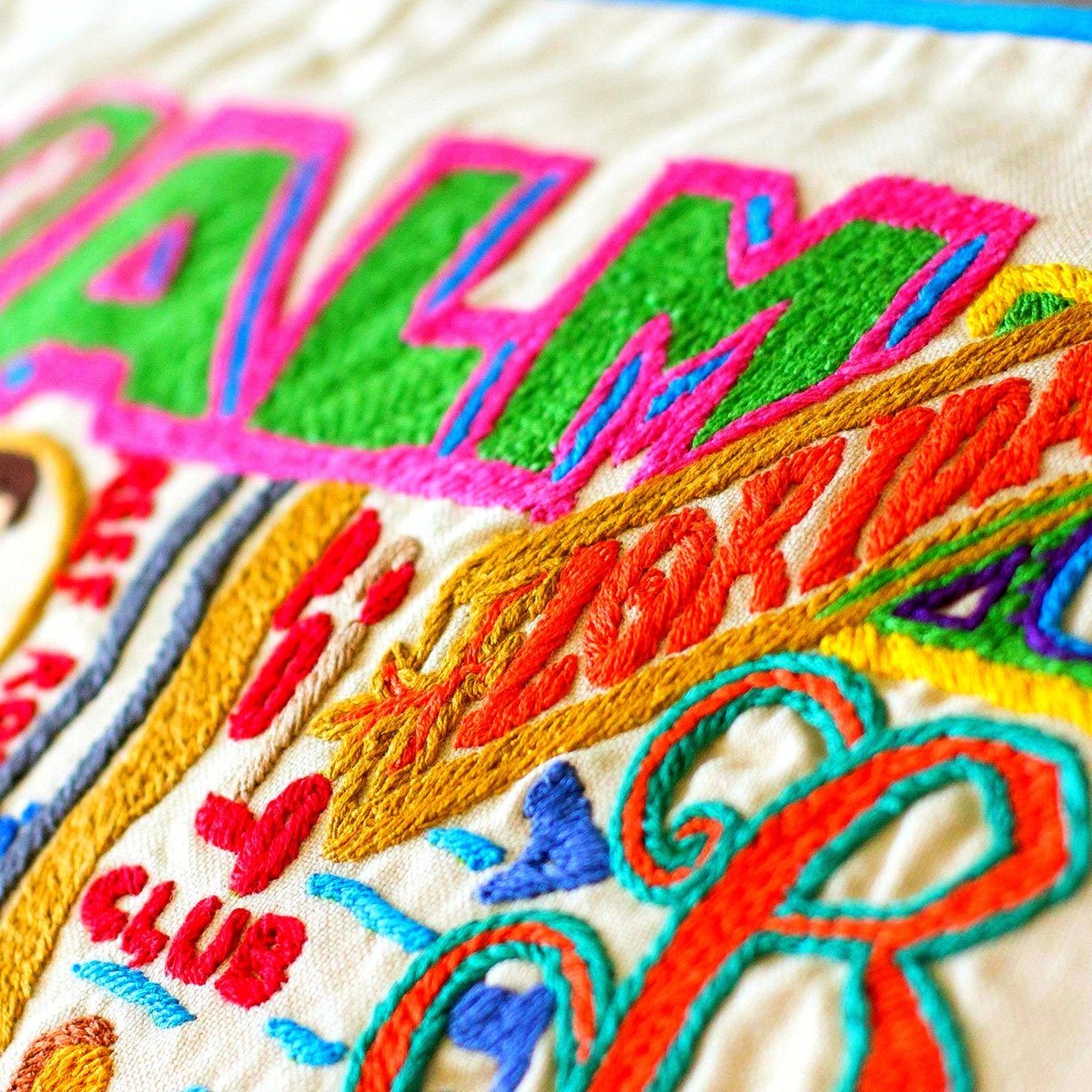 Palm Beach, FL Luxury Town Embroidered Travel Pillow - close-up detail of hand-embroidered needlepoint stitching