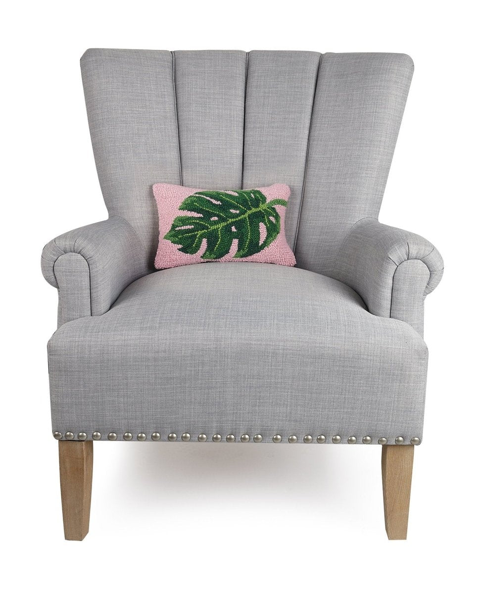 Palm Leaf Hooked Wool Throw Pillow on an armchair, showing the throw pillow at room scale, 8x12 inch