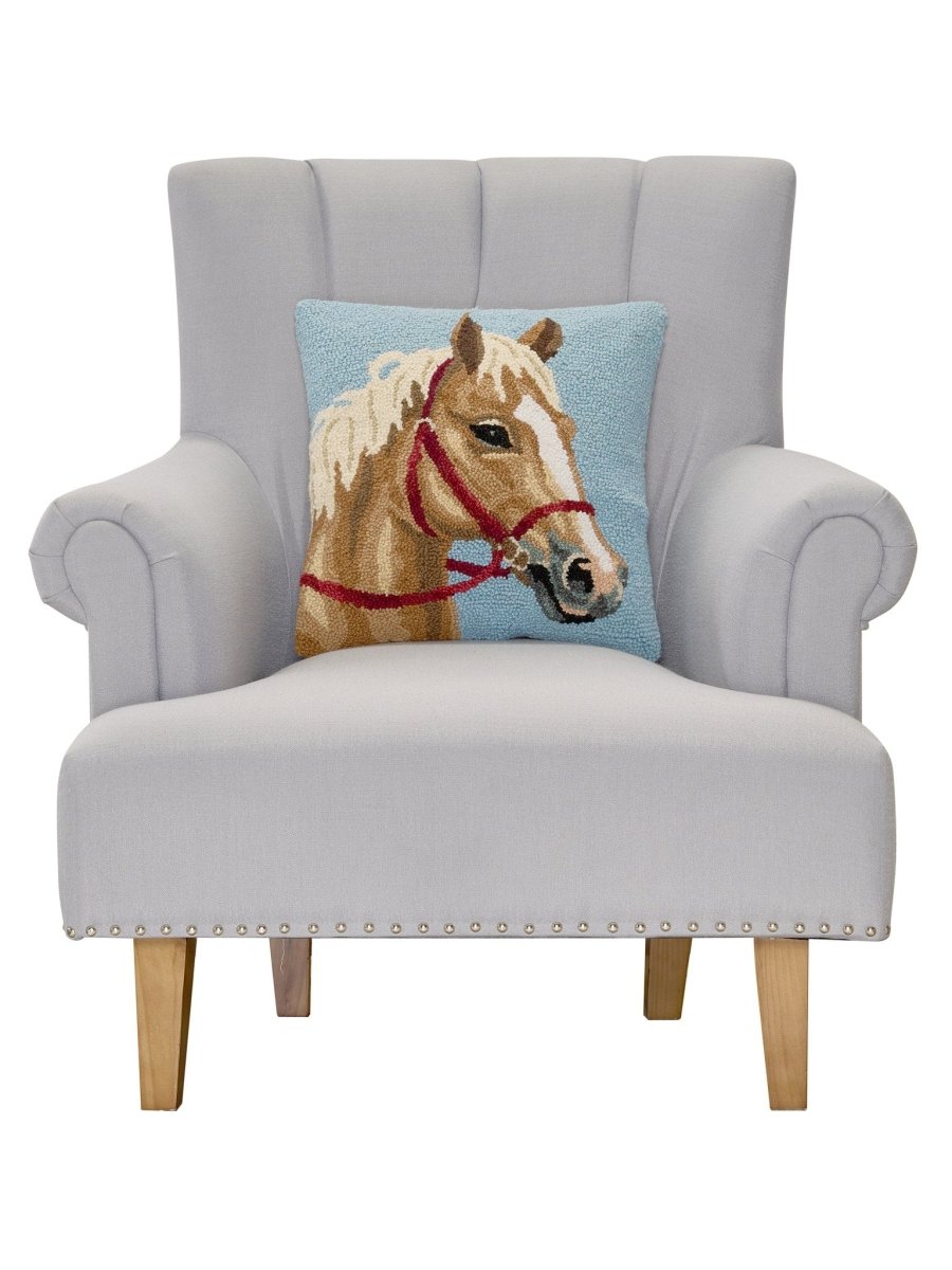 Palomino Horse Hooked Wool Throw Pillow on an armchair, showing the throw pillow at room scale, 16x16 inch