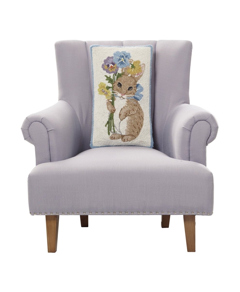 Pansy Rabbit Hooked Wool Easter Throw Pillow on an armchair, showing the throw pillow at room scale, 12x20 inch