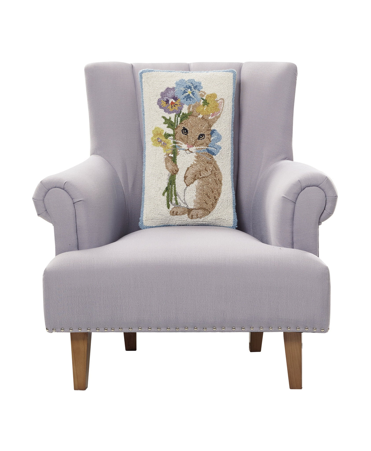 Pansy Rabbit Hooked Wool Easter Throw Pillow on an armchair, showing the throw pillow at room scale, 12x20 inch