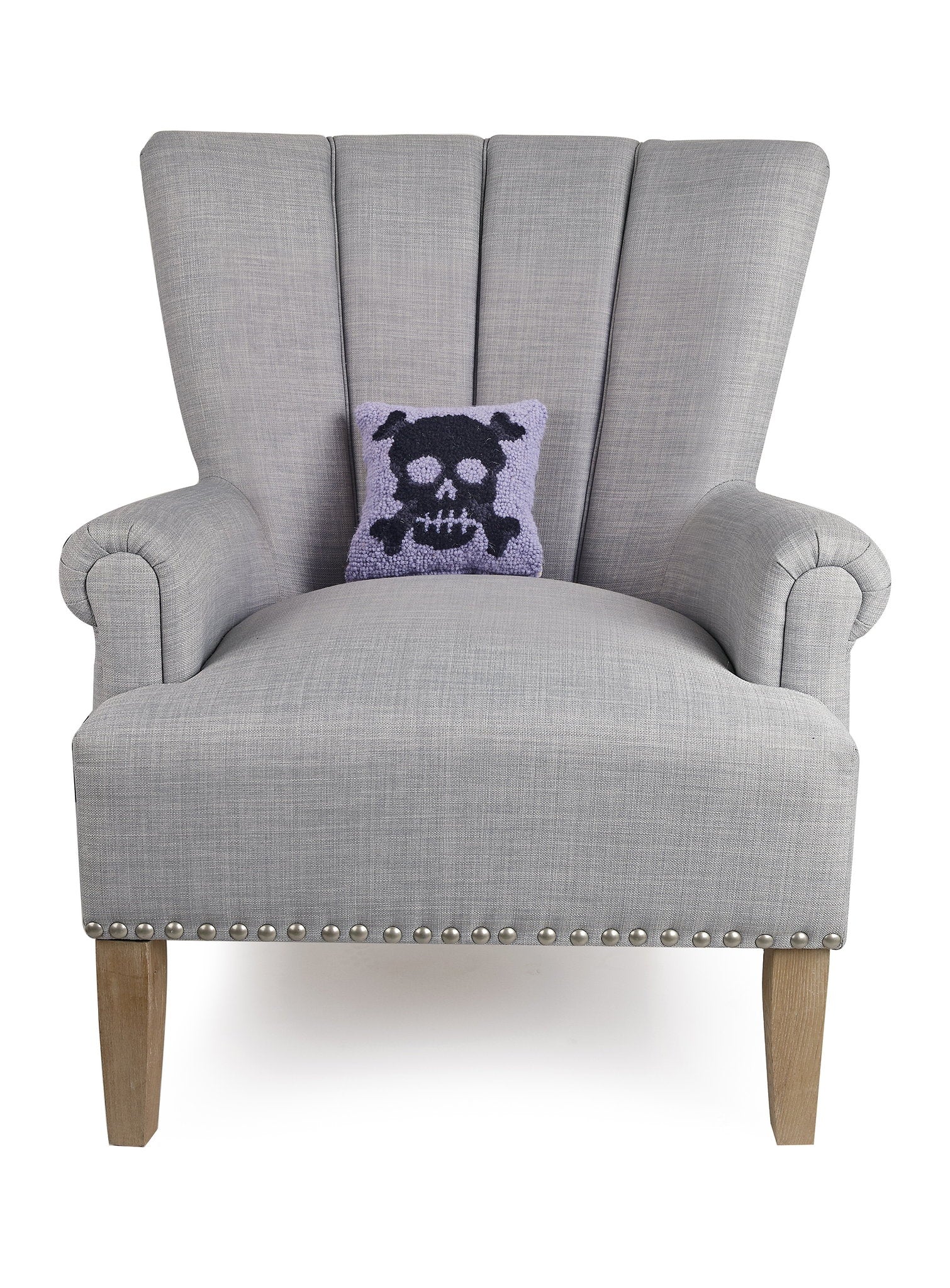 Pastel Skull Hooked Wool Halloween Throw Pillow on an armchair, showing the throw pillow at room scale, 8x8 inch