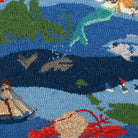 Close-up detail of the Patchwork Ocean hooked pillow showing dimensional wool loops