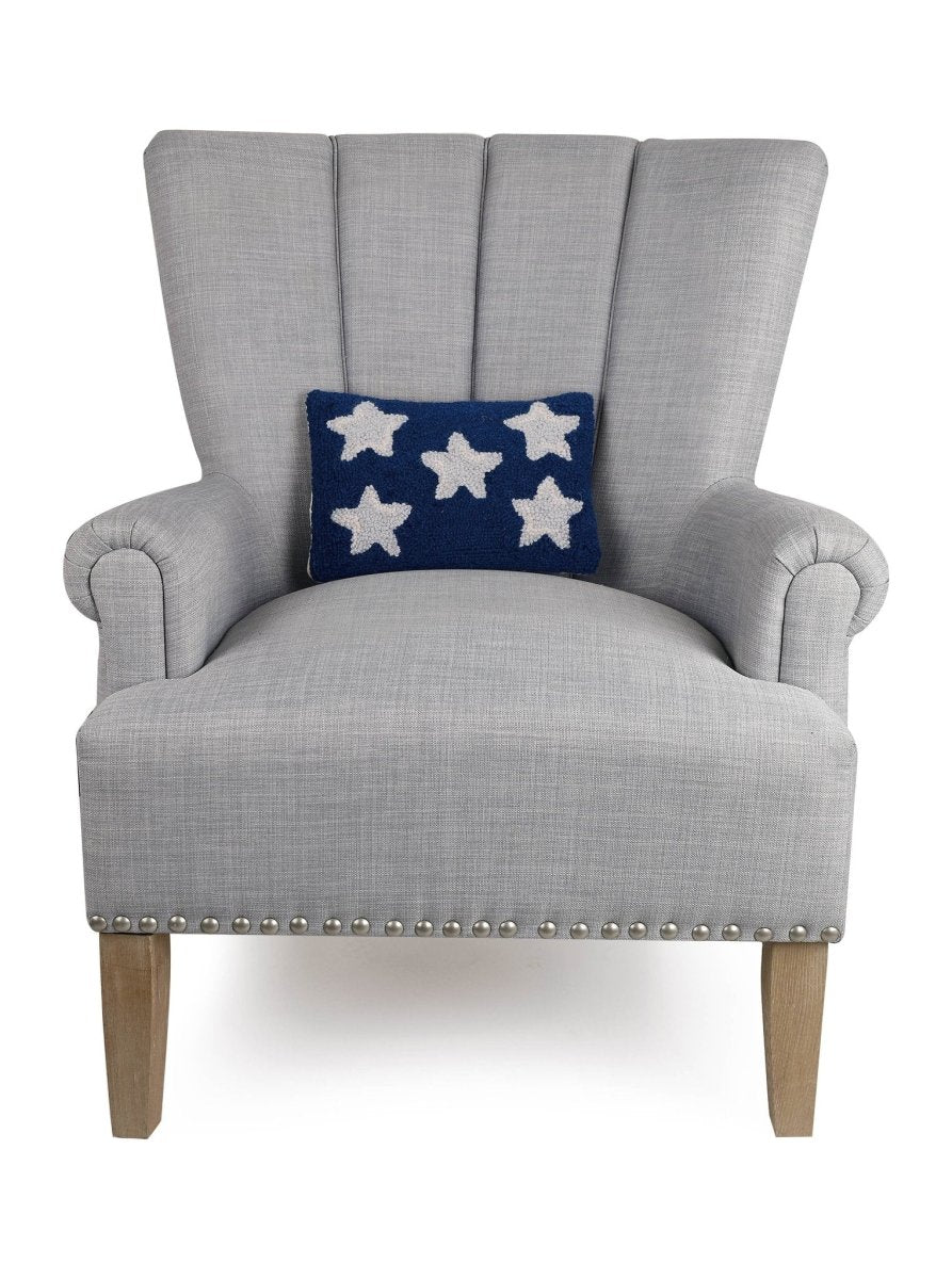 Patriotic Stars Hooked Wool Throw Pillow on an armchair, showing the throw pillow at room scale, 8x12 inch