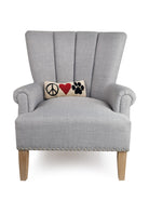 Peace Heart Paw Hooked Wool Throw Pillow on an armchair, showing the throw pillow at room scale, 12x5 inch