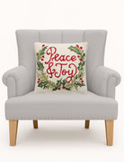 Peace & Joy Hooked Wool Christmas Throw Pillow on an armchair, showing the throw pillow at room scale, 16x16 inch