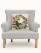 Pheasant Feather Wreath Hooked Wool Christmas Throw Pillow on an armchair, showing the throw pillow at room scale, 16x16 inch