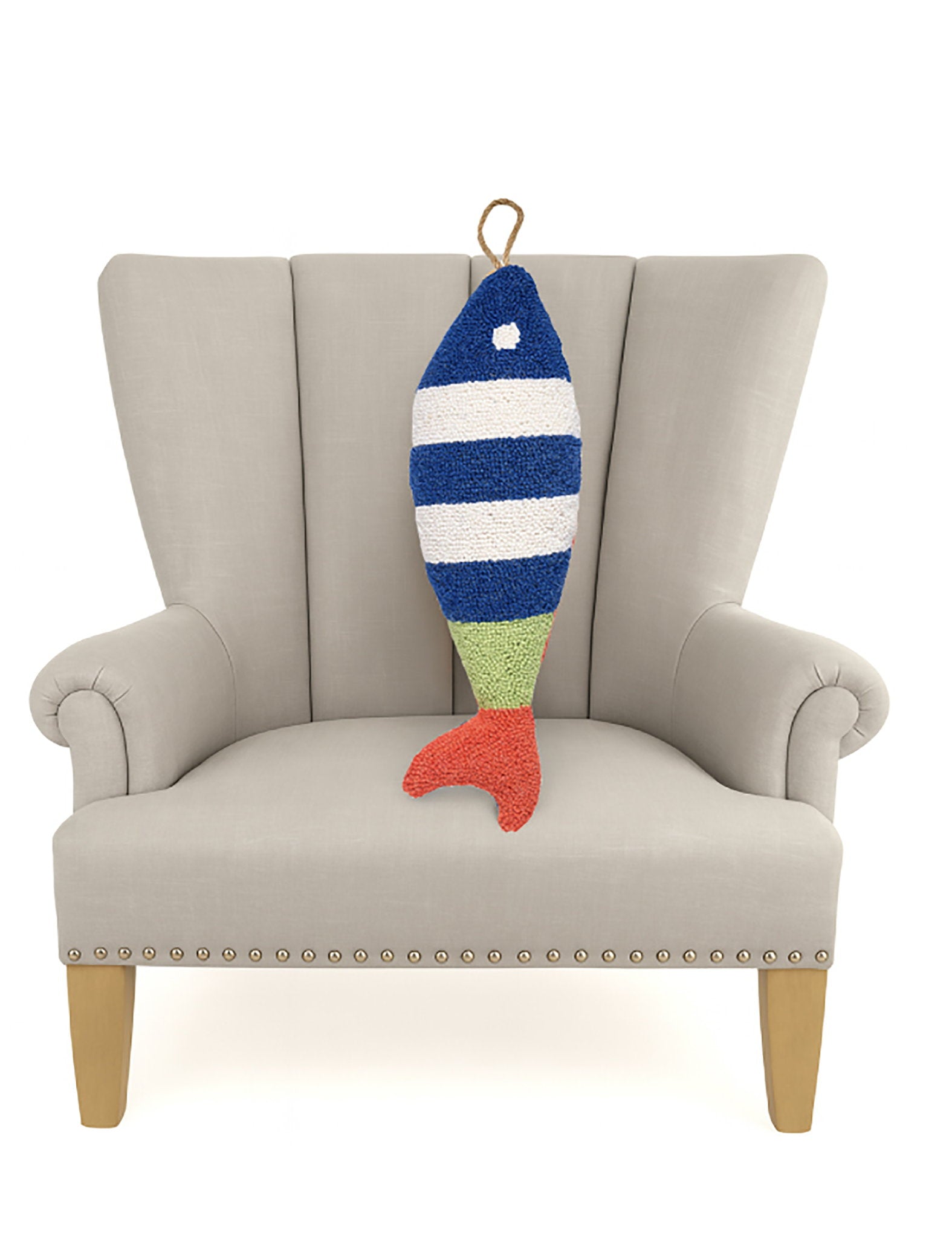 Picket Fish Shaped Hooked Wool Throw Pillow on an armchair, showing the throw pillow at room scale, 8x22 inch