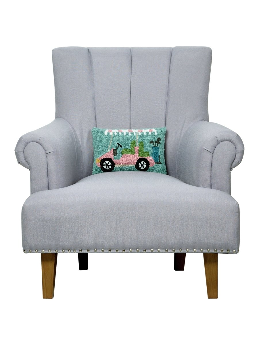 Pink Golf Cart Hooked Wool Christmas Throw Pillow on an armchair, showing the throw pillow at room scale, 8x12 inch