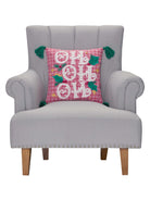 Pink Plaid Hohoho with Tassels Embroidered Christmas Throw Pillow on an armchair, showing the throw pillow at room scale, 16x16 inch