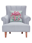 Pink Present Hooked Wool Christmas Throw Pillow on an armchair, showing the throw pillow at room scale, 16x16 inch