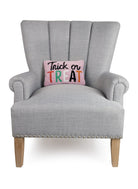 Pink Script Trick or Treat Hooked Wool Halloween Throw Pillow on an armchair, showing the throw pillow at room scale, 8x12 inch