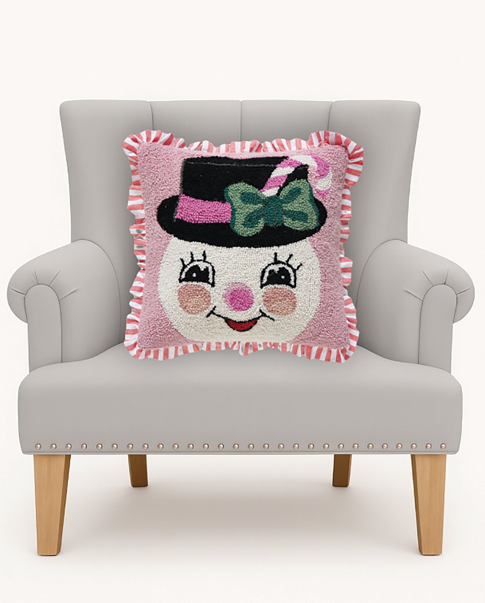 Pink Snowman Hooked Wool Christmas Throw Pillow 16x16 on an armchair, showing the throw pillow at room scale, 16x16 inch