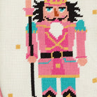 Closeup of Pink Turquoise Nutcracker Embroidered Needlepoint Christmas Stocking showing stitch texture and craftsmanship detail
