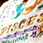 Pisces Astrology Zodiac Embroidered Throw Pillow - close-up detail of hand-embroidered needlepoint stitching