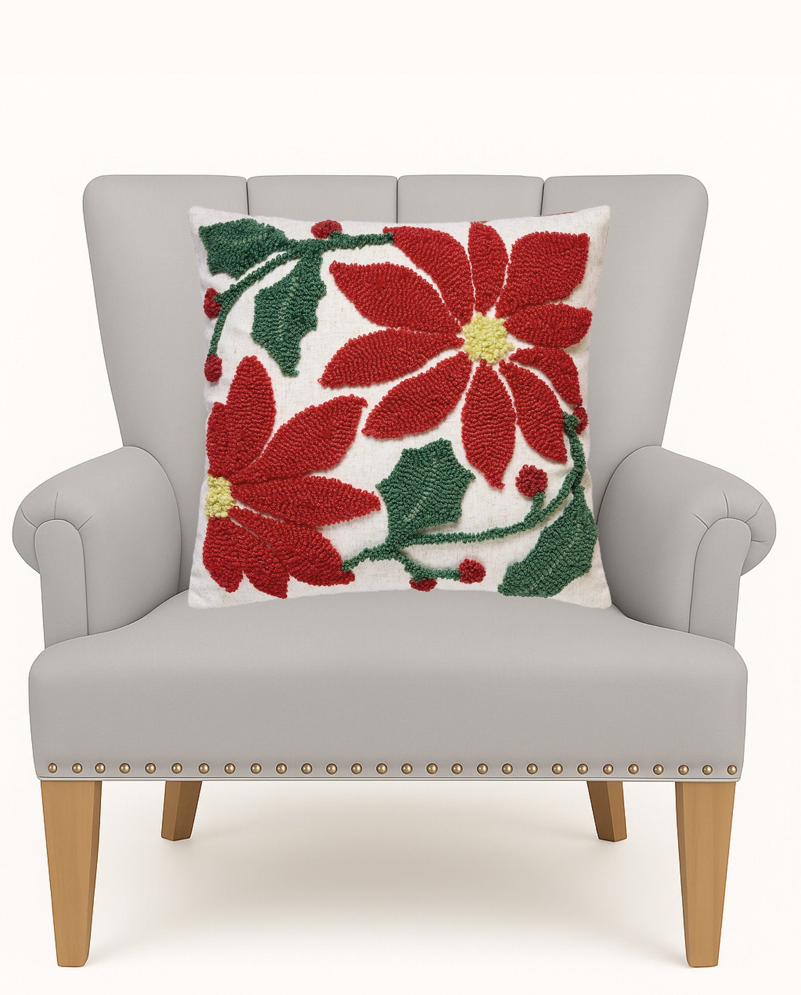 Poinsettia Tufted Hooked Wool Christmas Throw Pillow on an armchair, showing the throw pillow at room scale, 16x16 inch