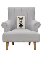 Poker King Hooked Wool Throw Pillow on an armchair, showing the throw pillow at room scale, 8x12 inch