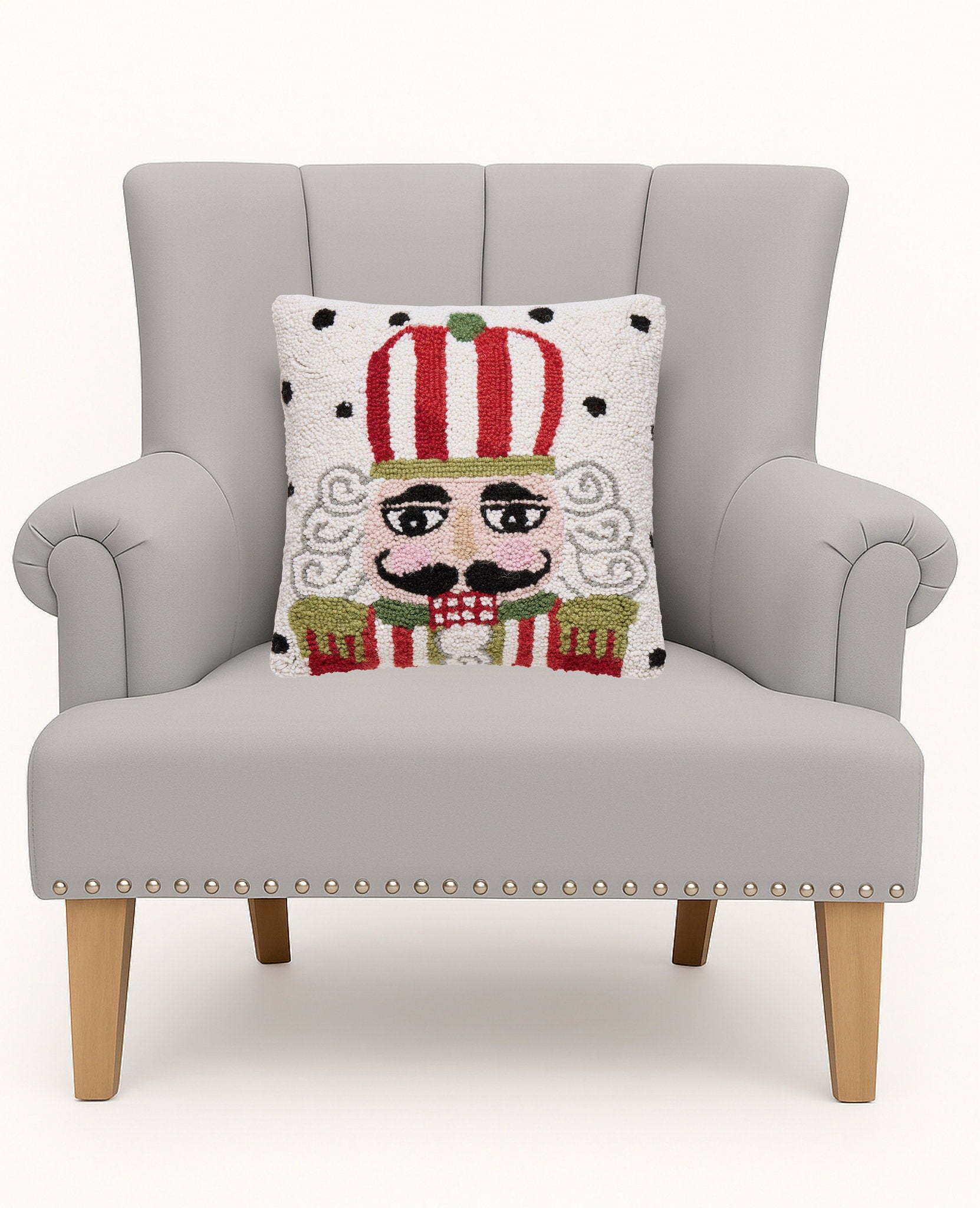 Polka Nutcracker Hooked Wool Christmas Throw Pillow on an armchair, showing the throw pillow at room scale, 14x14 inch