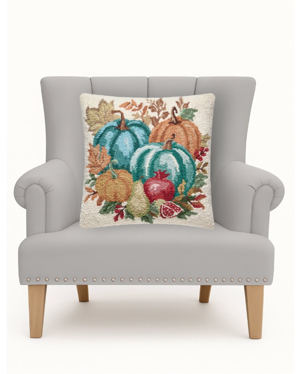 Pomegranate Teal Harvest Hooked Wool Fall Harvest Throw Pillow on an armchair, showing the throw pillow at room scale, 18x18 inch