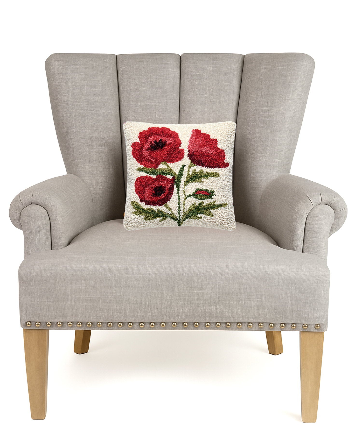 Poppies Hooked Wool Throw Pillow on an armchair, showing the throw pillow at room scale, 10x10 inch
