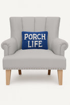 Porch Life Hooked Wool Throw Pillow on an armchair, showing the throw pillow at room scale, 8x12 inch