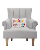 Positive Energy Hooked Wool Throw Pillow on an armchair, showing the throw pillow at room scale, 8x12 inch