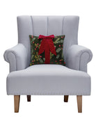Present with Bow Embroidered Christmas Throw Pillow on an armchair, showing the throw pillow at room scale, 14x16 inch