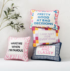 Pretty Good Embroidered Needlepoint Throw Pillow shown alongside other designs in the same collection, 10x14 inch