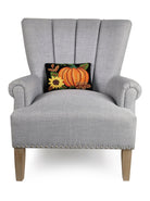 Pumpkin Sunflower Hooked Wool Fall Harvest Throw Pillow on an armchair, showing the throw pillow at room scale, 8x12 inch