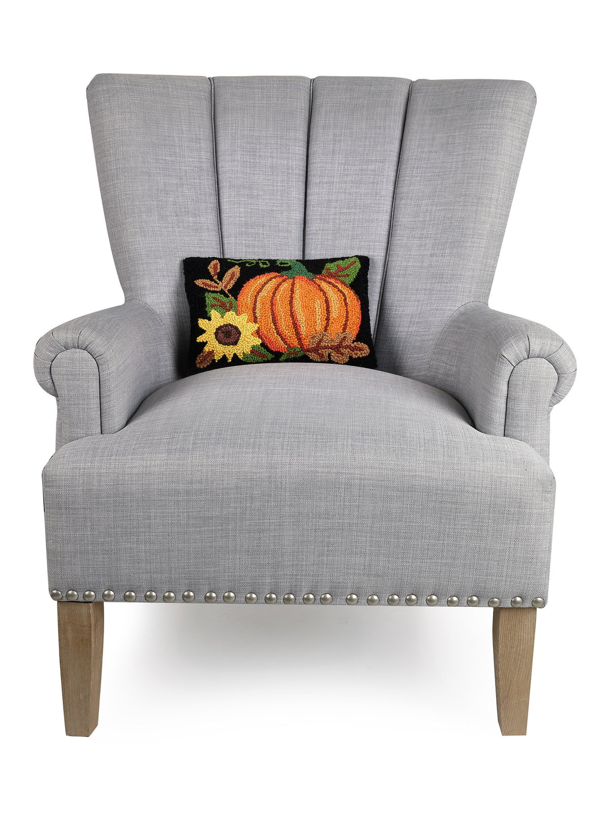 Pumpkin Sunflower Hooked Wool Fall Harvest Throw Pillow on an armchair, showing the throw pillow at room scale, 8x12 inch