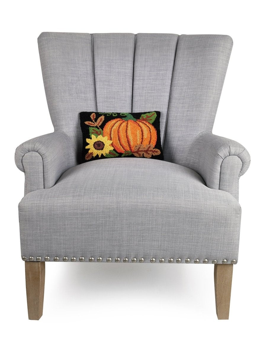 Pumpkin Sunflower Hooked Wool Fall Harvest Throw Pillow on an armchair, showing the throw pillow at room scale, 8x12 inch