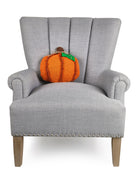 Pumpkin with Leaf Applique Hooked Wool Fall Harvest Throw Pillow on an armchair, showing the throw pillow at room scale, 12x12 inch