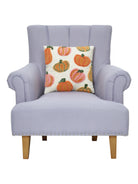 Pumpkins All Over Hooked Throw Pillow on an armchair, showing the throw pillow at room scale, 16x16 inch