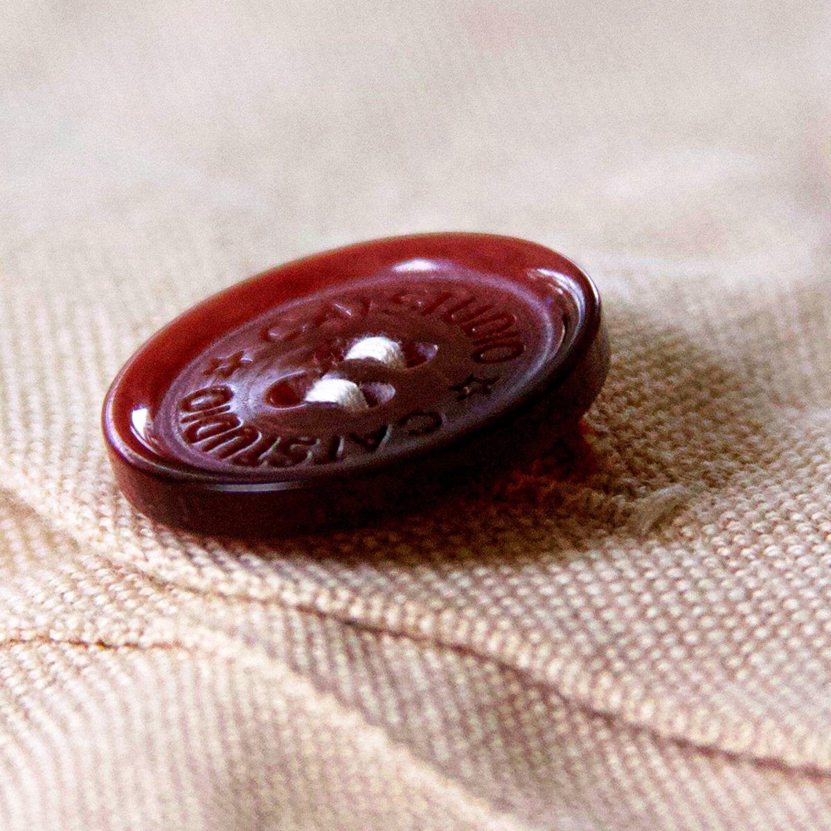 Quebec French Heritage Travel Embroidered Throw Pillow - detail of decorative button closure