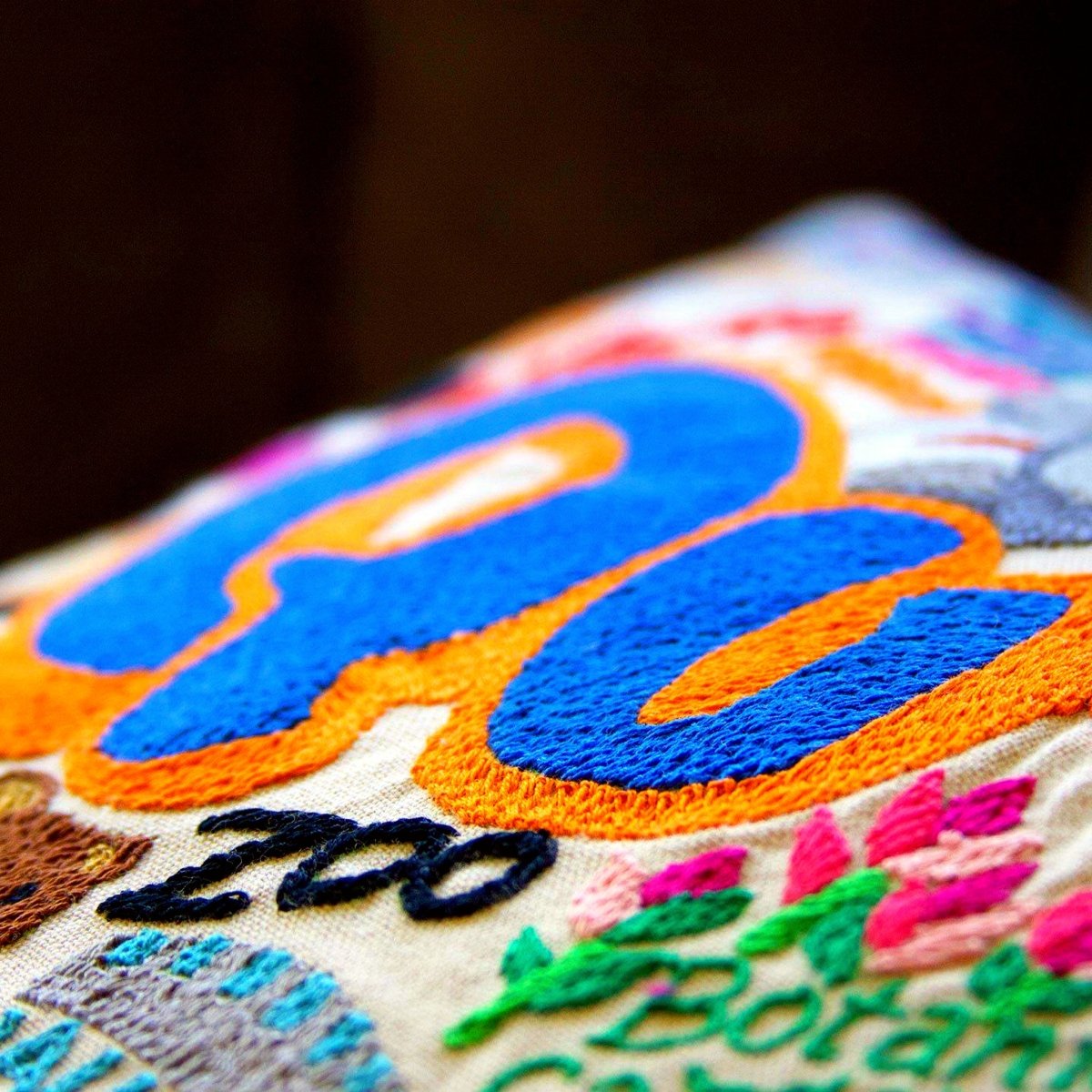 Queens, NY Borough City Embroidered Travel Pillow - close-up detail of hand-embroidered needlepoint stitching