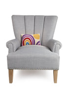 Rainbow and Sun Hooked Wool Throw Pillow on an armchair, showing the throw pillow at room scale, 8x12 inch