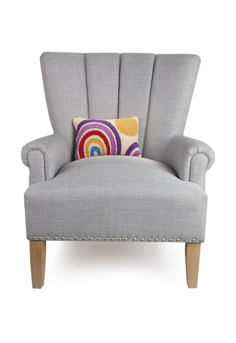 Rainbow and Sun Hooked Wool Throw Pillow on an armchair, showing the throw pillow at room scale, 8x12 inch