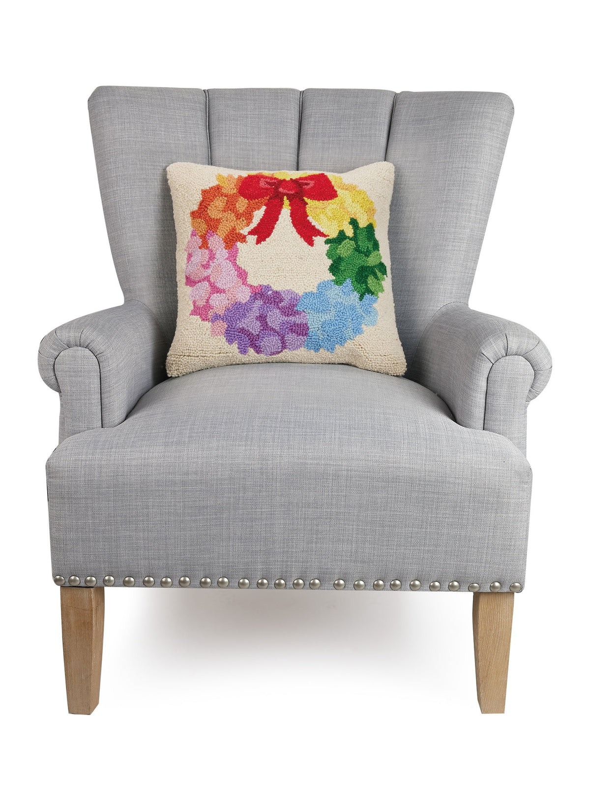 Rainbow Wreath Hooked Wool Christmas Throw Pillow on an armchair, showing the throw pillow at room scale, 16x16 inch