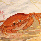 Red Crab And Sea Star Coastal pillow fabric closeup showing hand-embroidered needlepoint wool texture and color detail