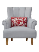 Red Folk Branch Embroidered Christmas Throw Pillow on an armchair, showing the throw pillow at room scale, 12x18 inch
