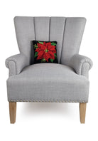 Red on Black Poinsettia Hooked Wool Christmas Throw Pillow on an armchair, showing the throw pillow at room scale, 10x10 inch