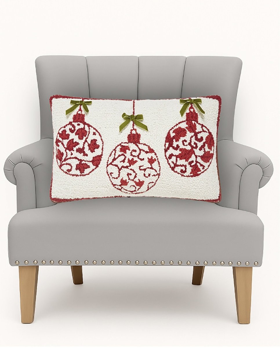 Red Ornaments with Real Bow Hooked Wool Christmas Throw Pillow on an armchair, showing the throw pillow at room scale, 12x20 inch
