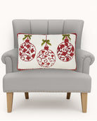 Red Ornaments with Real Bow Hooked Wool Christmas Throw Pillow on an armchair, showing the throw pillow at room scale, 12x20 inch