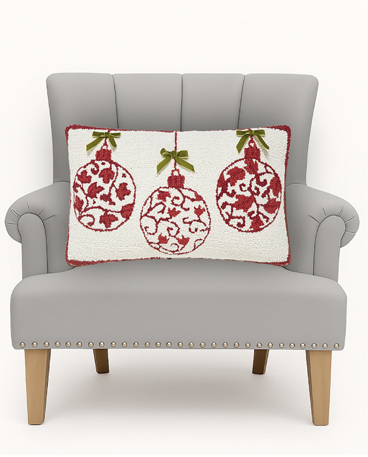 Red Ornaments with Real Bow Hooked Wool Christmas Throw Pillow on an armchair, showing the throw pillow at room scale, 12x20 inch