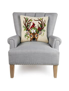 Reindeer and Cardinal Hooked Wool Christmas Throw Pillow on an armchair, showing the throw pillow at room scale, 18x18 inch