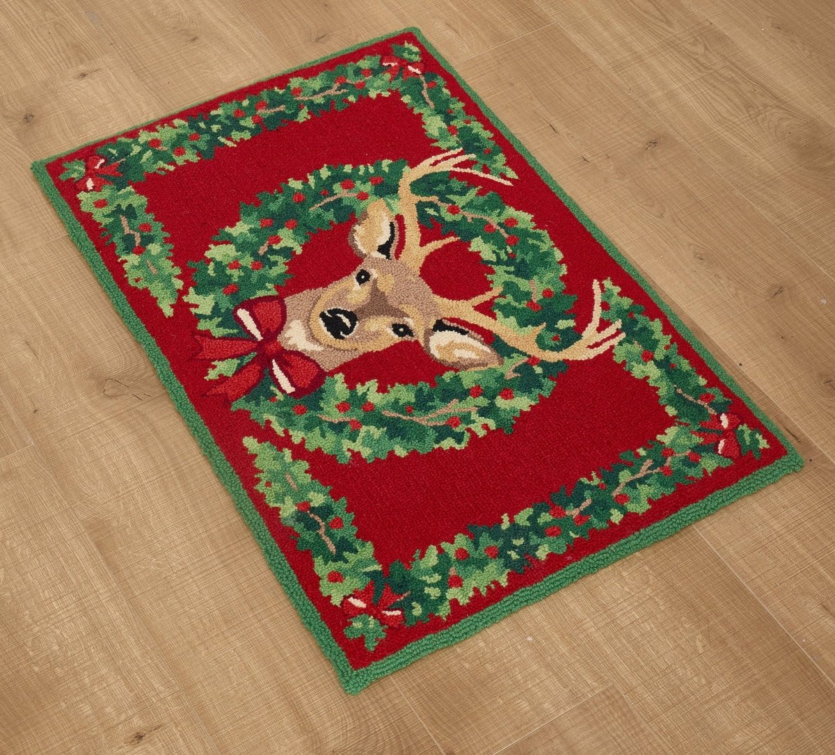 Reindeer Wreath Hooked Wool Christmas Rug styled in a room setting, 2x3 feet
