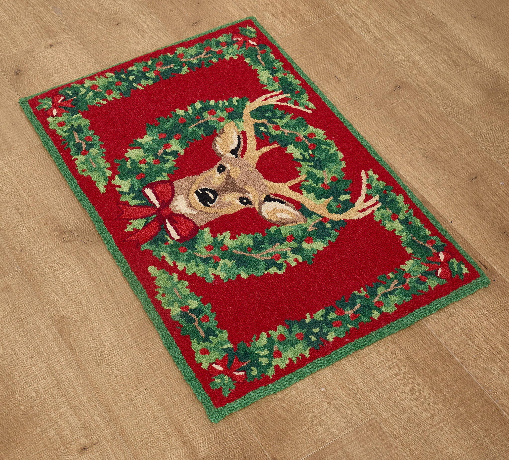 Reindeer Wreath Hooked Wool Christmas Rug styled in a room setting, 2x3 feet