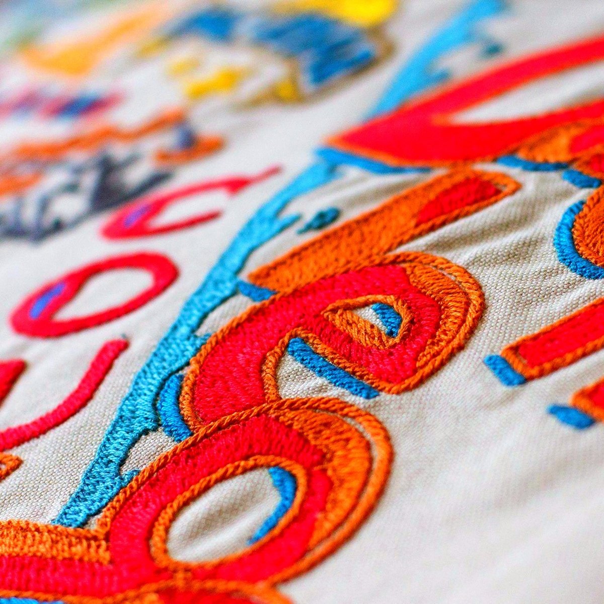 San Diego, CA Sunny City Embroidered Travel Pillow - close-up detail of hand-embroidered needlepoint stitching