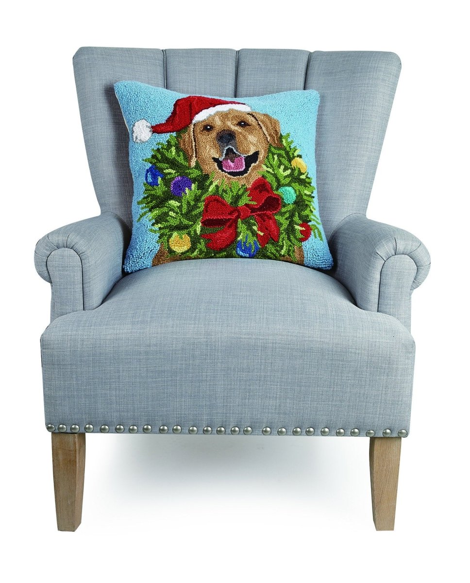 Santa Golden Labr Wreath Hooked Wool Christmas Throw Pillow on an armchair, showing the throw pillow at room scale, 18x18 inch